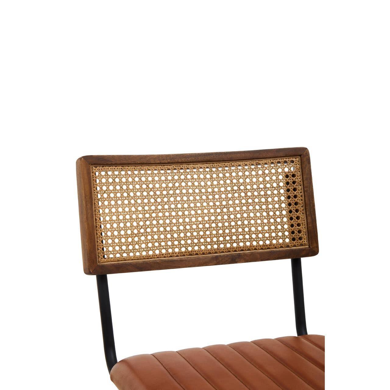 Rattan dining chair with metal frame and brown padded seat, close-up of backrest