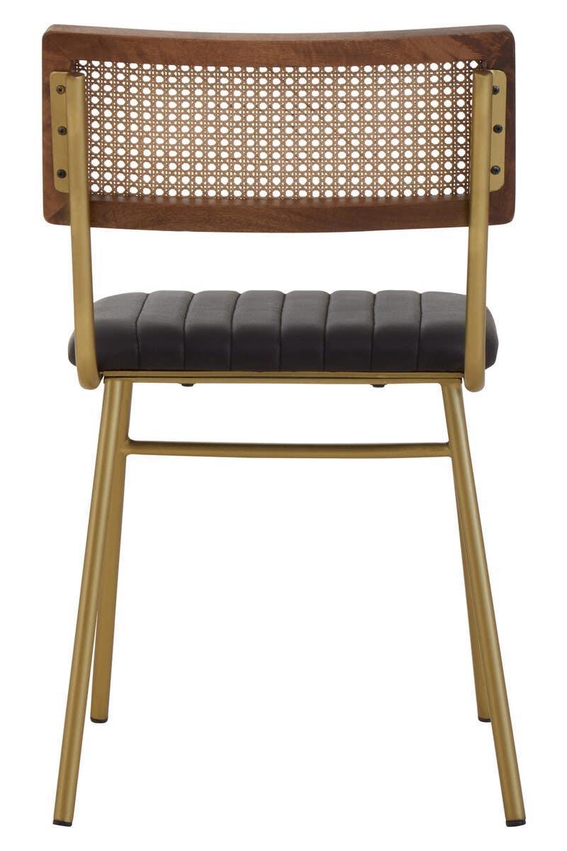 Contemporary dining chair with cane back, gold frame, and black upholstered seat, rear view