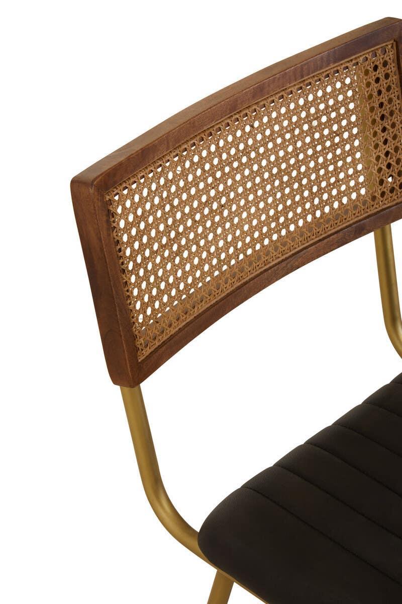 Rattan back dining chair with walnut frame, gold legs, and black upholstered seat