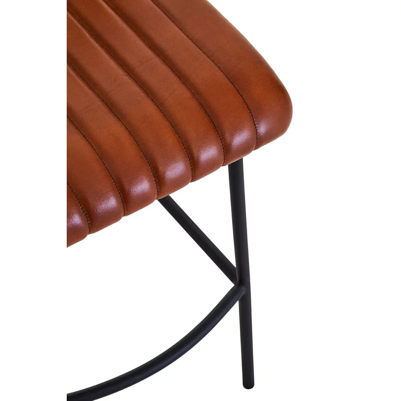 Brown faux leather dining bench seat with vertical stitching and black metal legs closeup