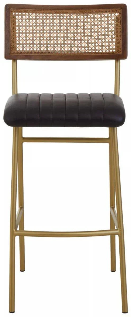 Black upholstered bar stool with gold legs and rattan backrest, front view