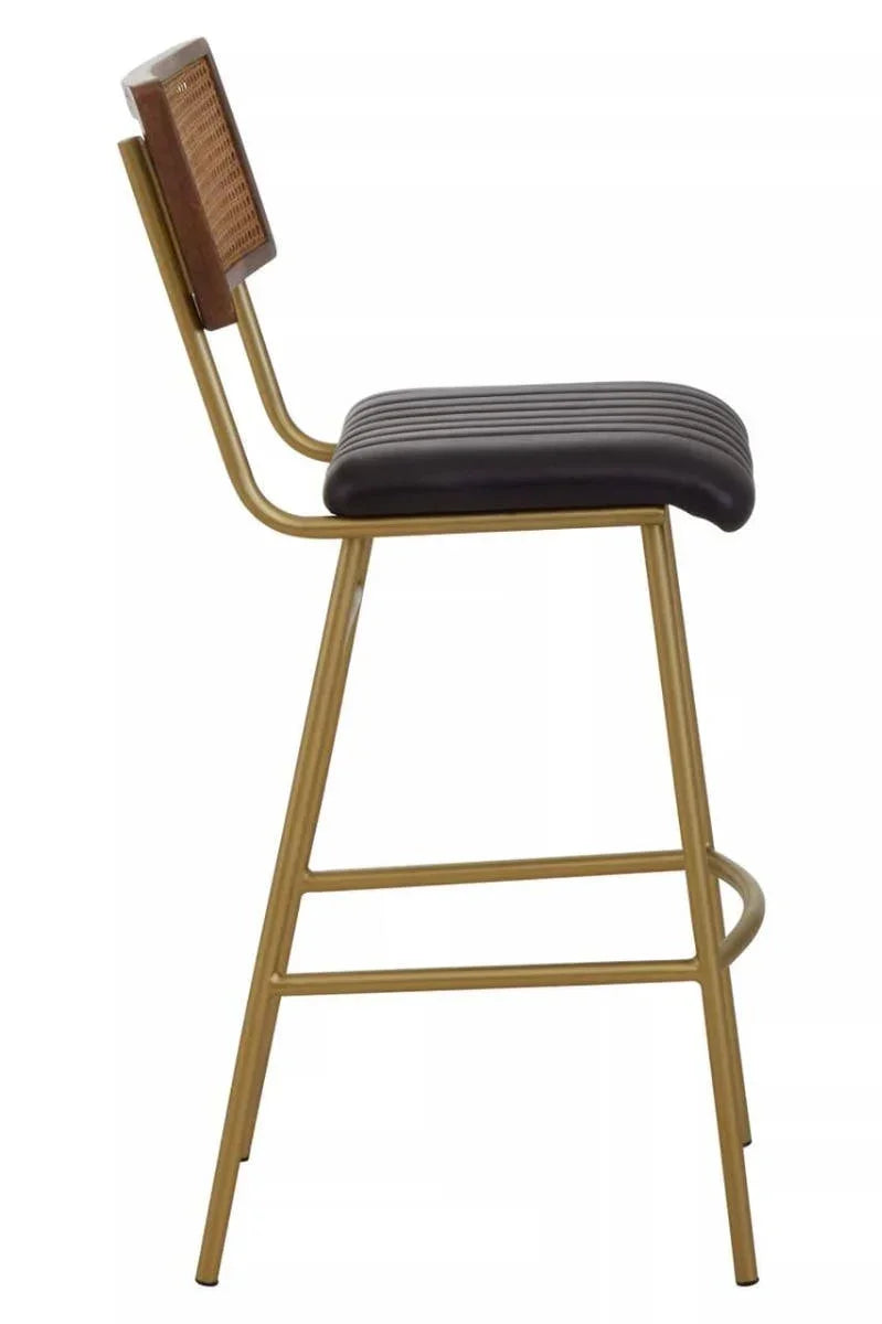 Bar stool with gold metal frame, ribbed black seat and cane backrest, side view