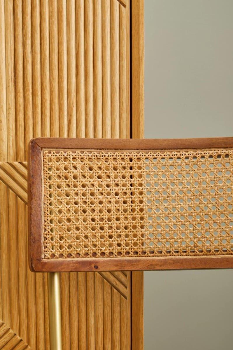 Closeup of rattan chair back with wooden frame against slatted wood panel
