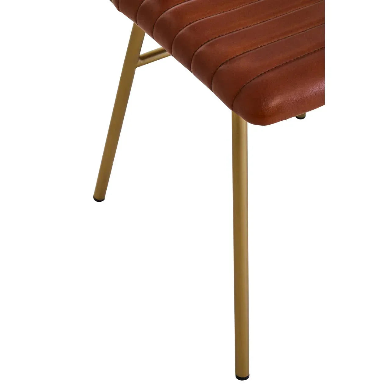 Closeup of brown faux leather dining chair seat with gold metal legs