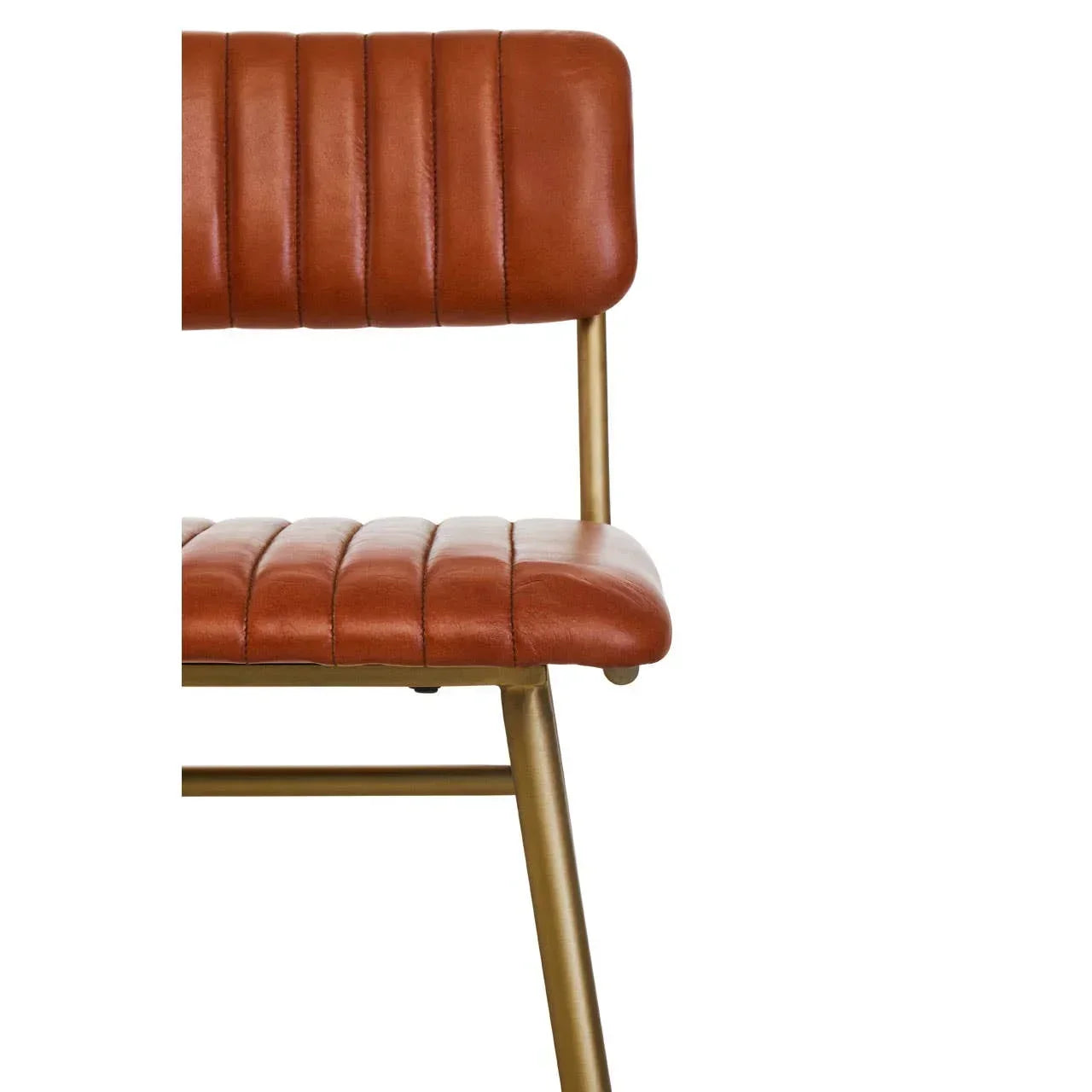 Closeup of brown leather dining chair with gold metal legs and stitched seat detail