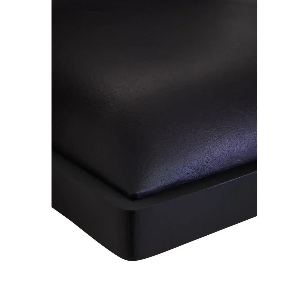 Closeup of black faux leather bed frame corner with smooth texture