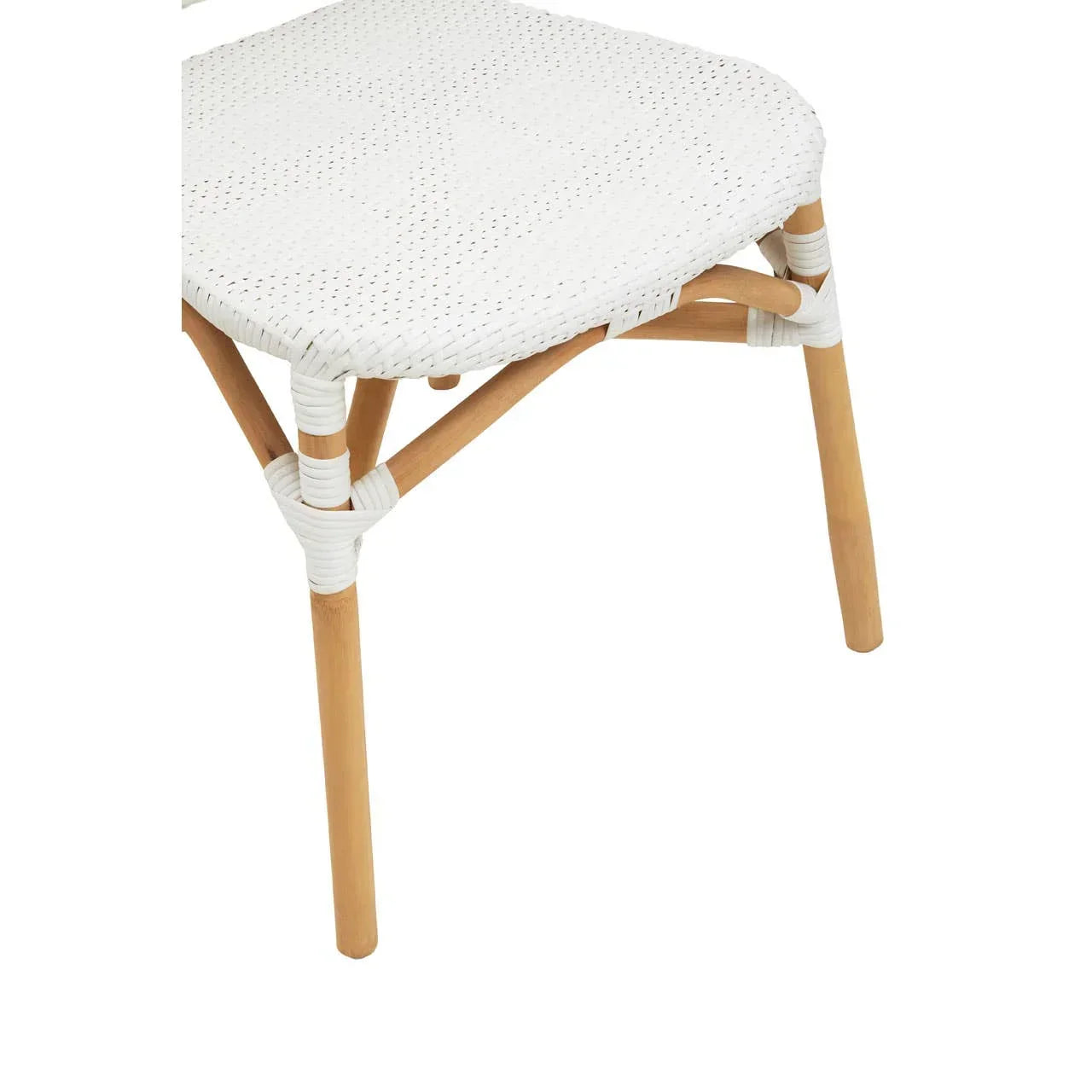 White woven rattan dining chair seat with light wood legs, close-up angle