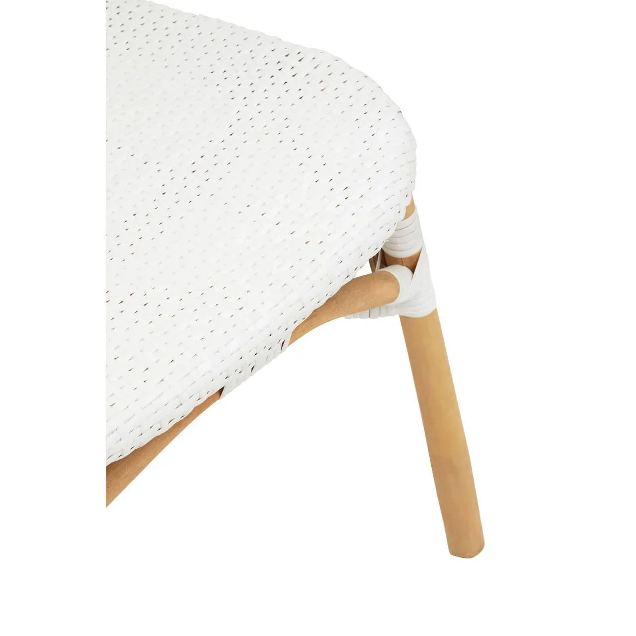 Closeup of white rattan dining chair seat with natural wood legs