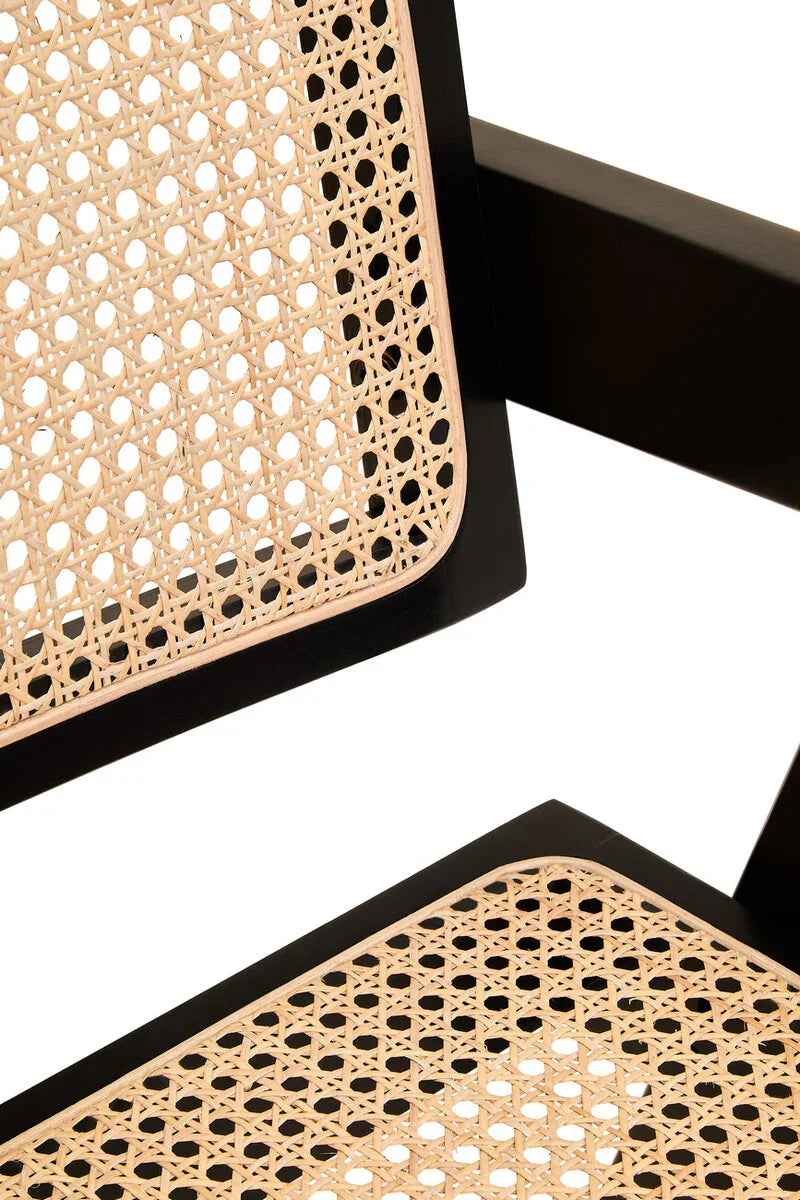 Close view of rattan dining chair seat and backrest with black wooden frame