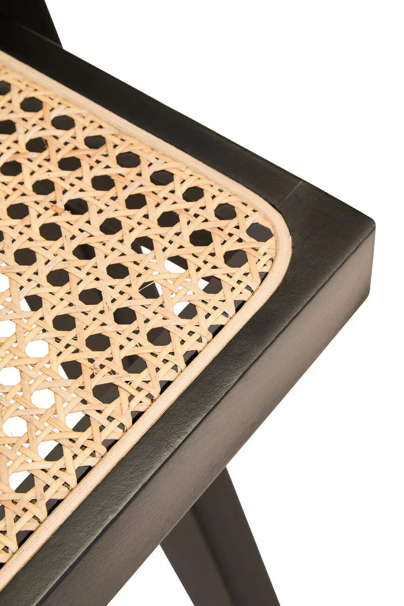 Close up of rattan dining chair seat with black wooden frame