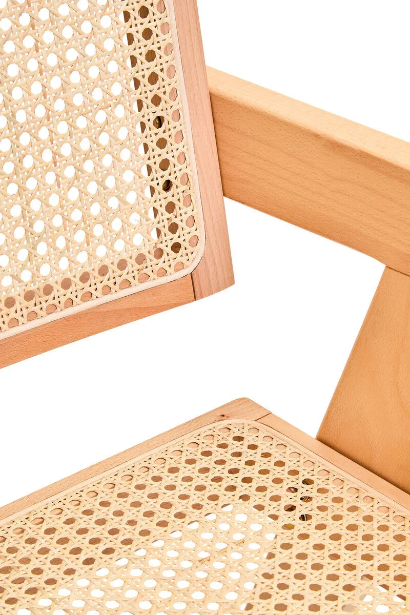 Close-up of natural wood cane chair showing woven rattan seat and backrest detail