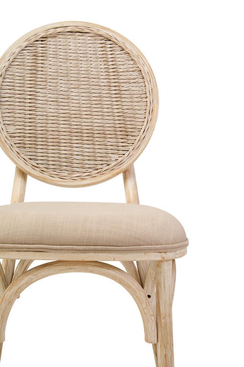 Natural rattan dining chair with round woven back and beige upholstered seat, front view