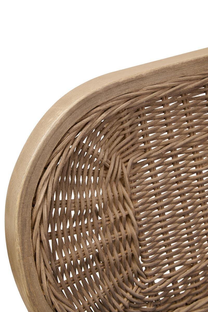 Close-up of rattan chair backrest with natural wood frame and woven texture detail