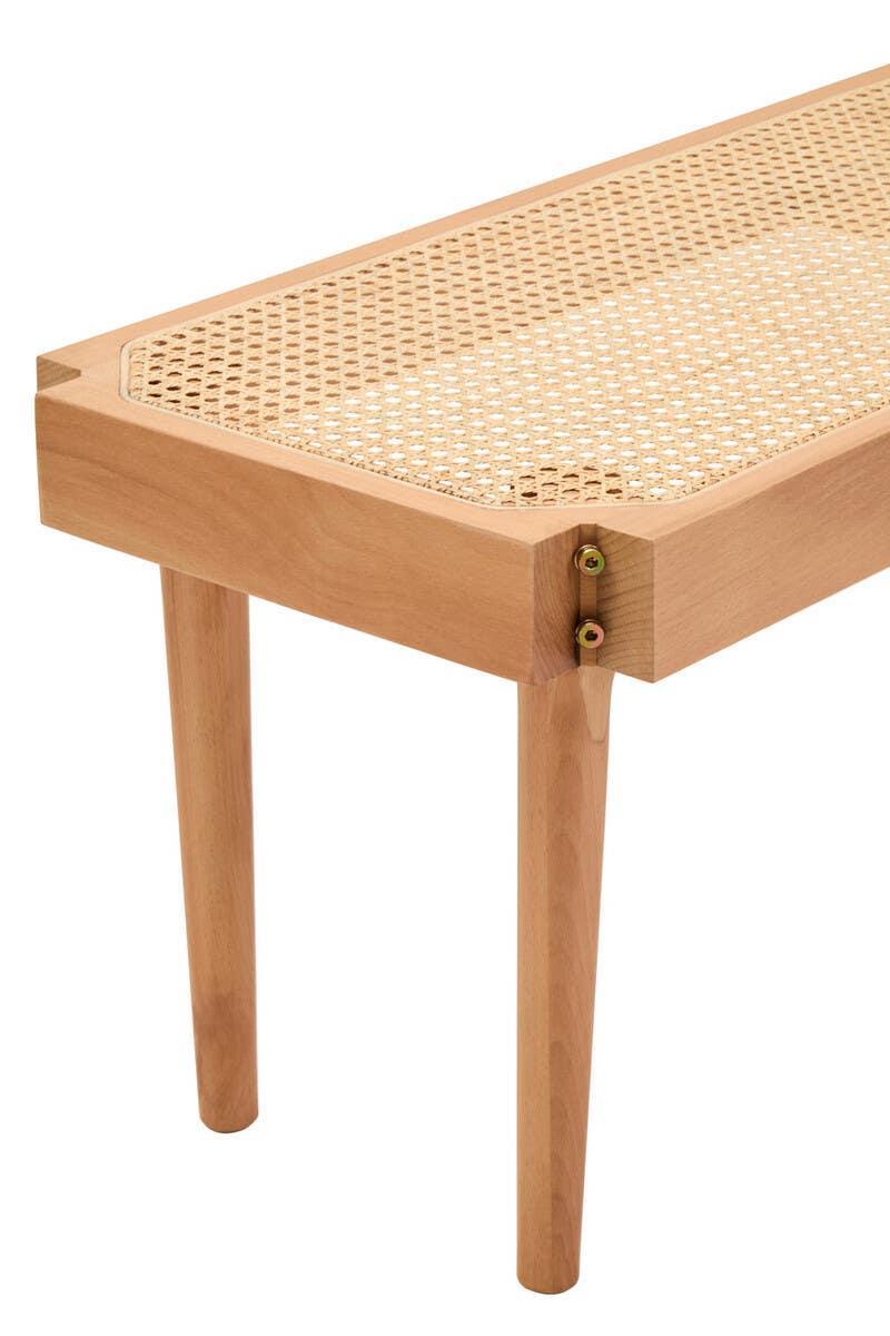 wooden bench with cane seat and tapered legs, close-up corner view