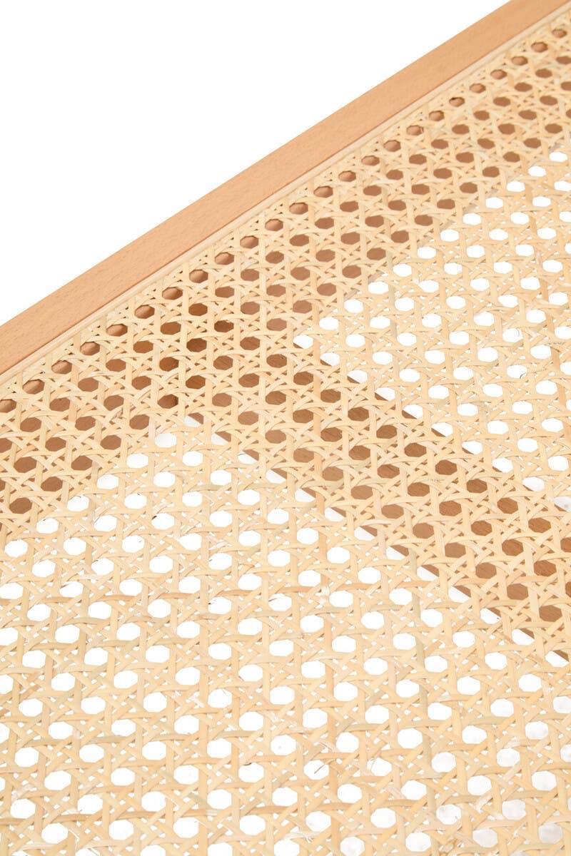 Close up of rattan cane webbing on a light wood furniture panel
