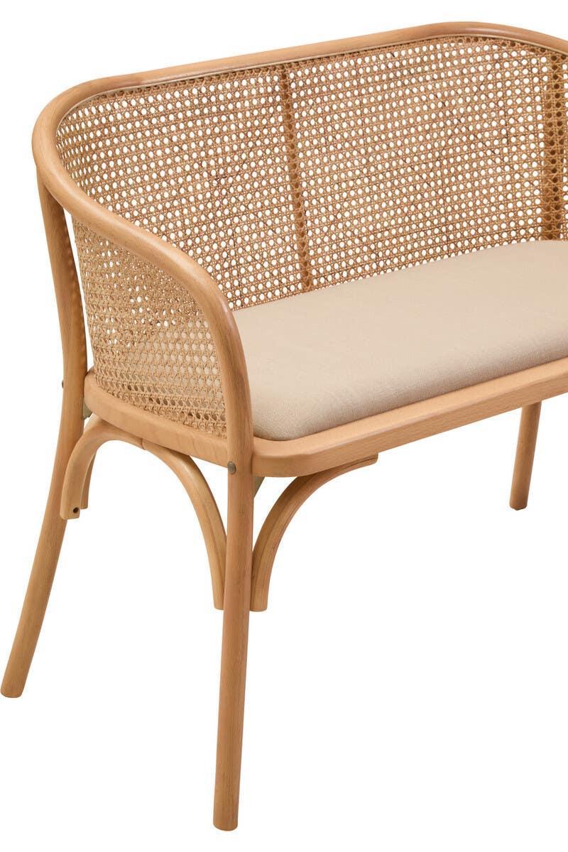 Rattan wooden armchair with curved back and beige cushioned seat