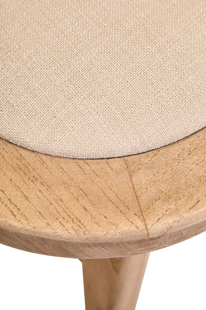 Close-up of beige fabric upholstered wooden stool seat with natural wood grain detail