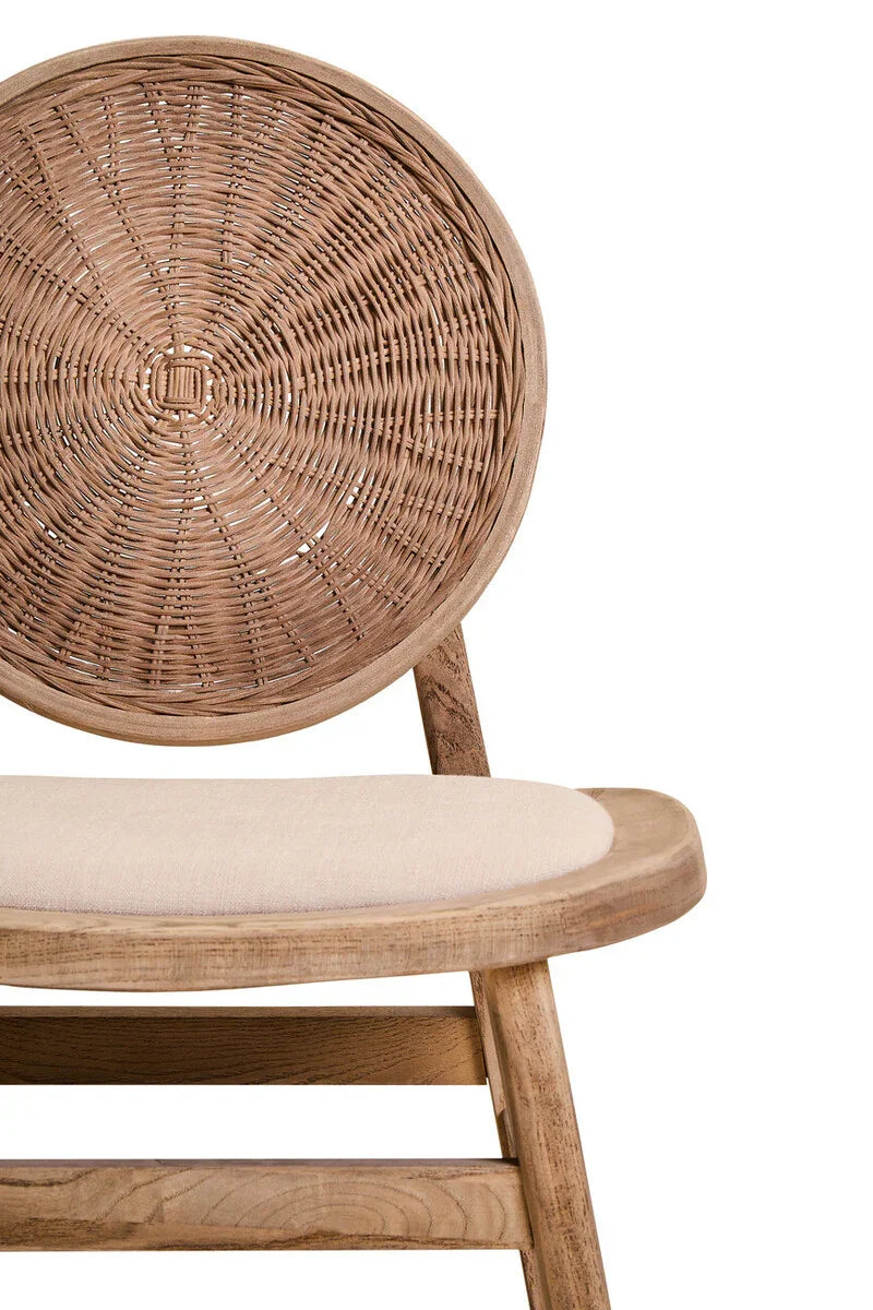Rattan dining chair with round woven backrest and cushioned beige seat, wooden frame detail