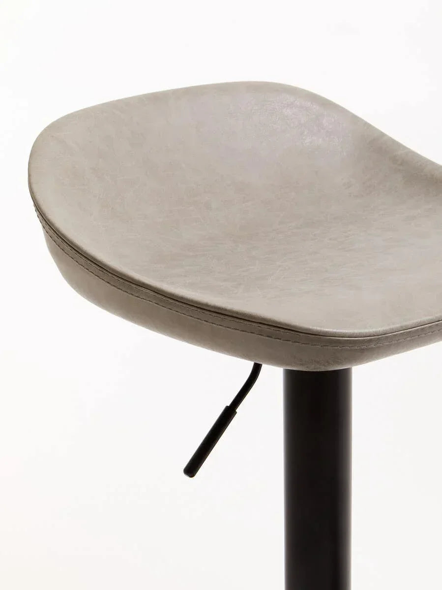 Close-up of grey faux leather bar stool seat with black adjustable metal base