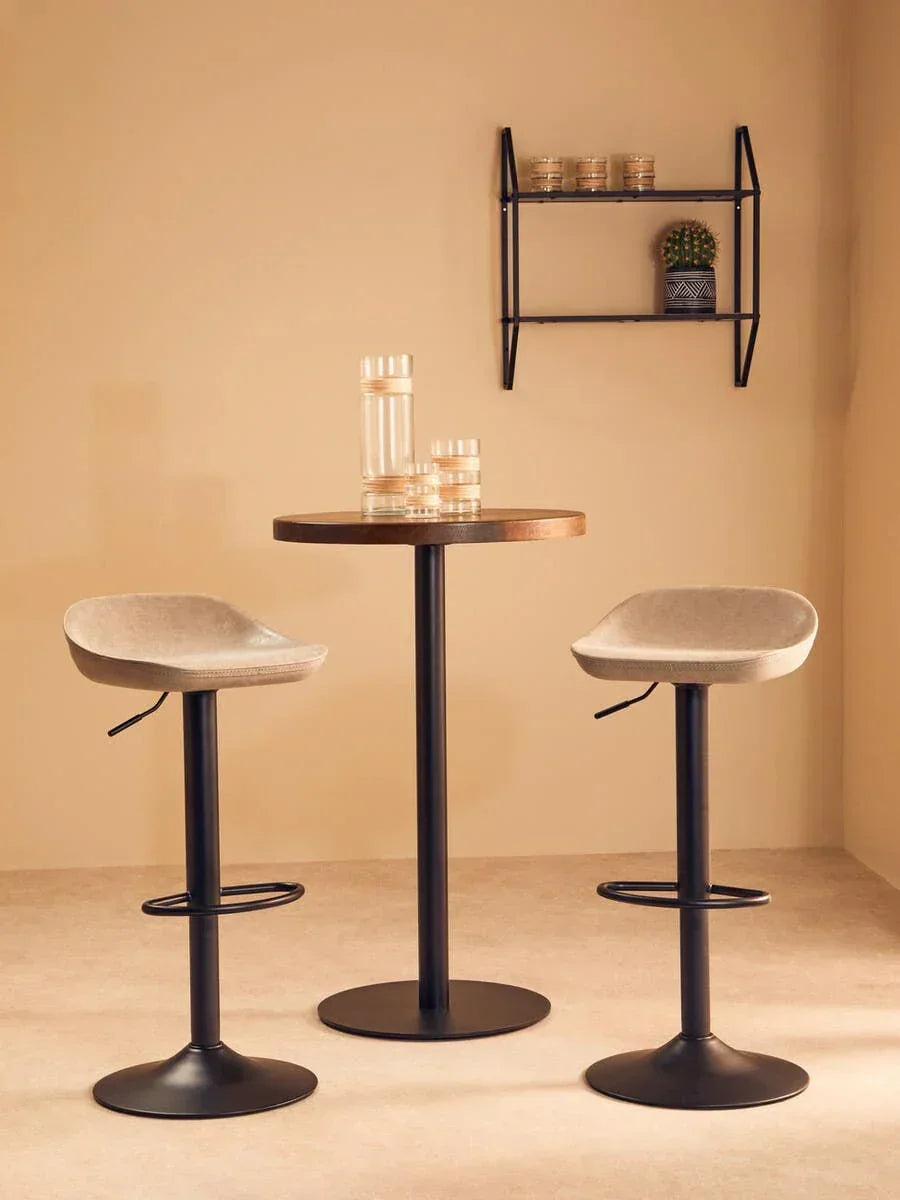 Modern bar table set with two beige swivel bar stools and black bases in minimalist room