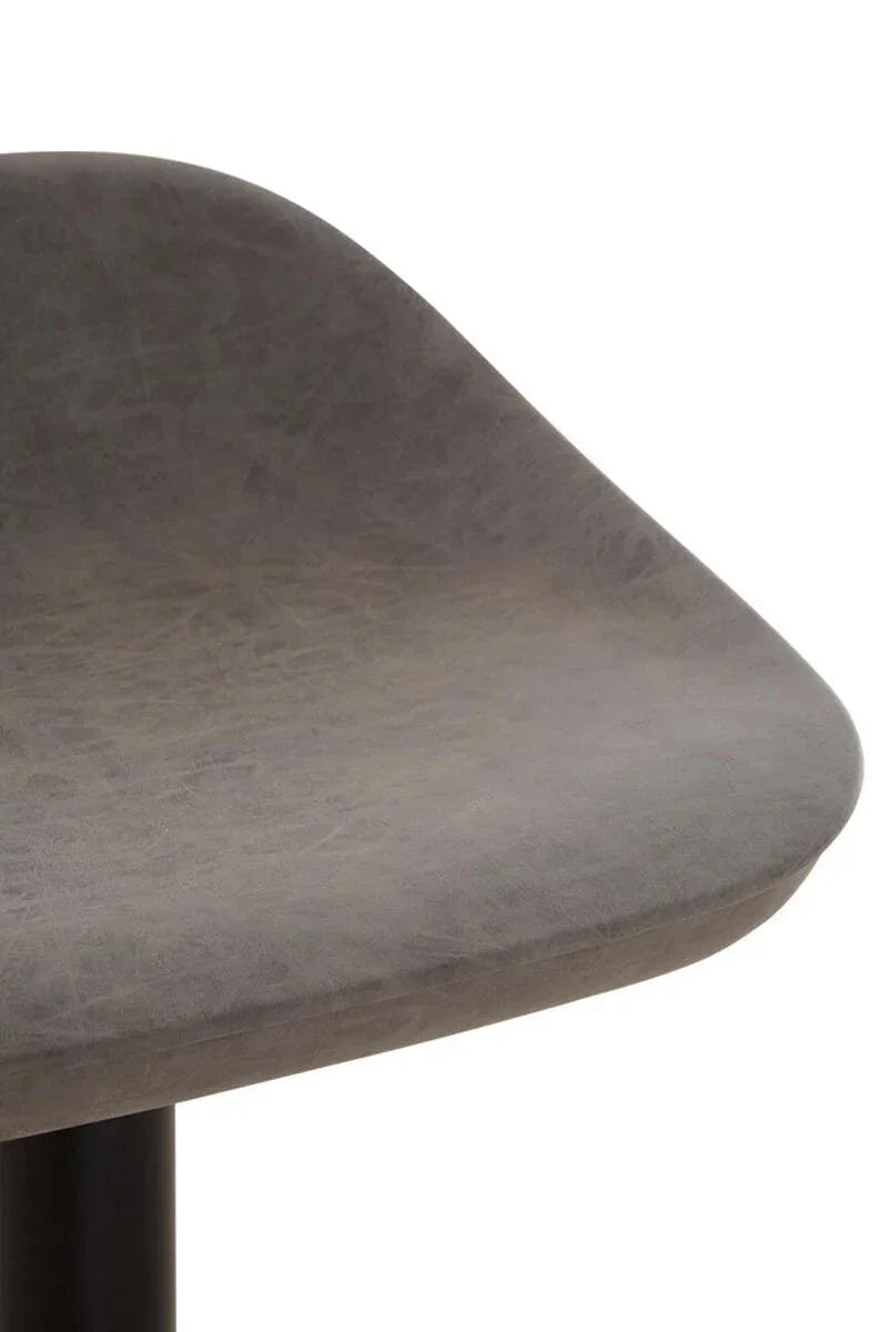 Closeup of grey faux leather dining chair seat with curved edge and black metal leg