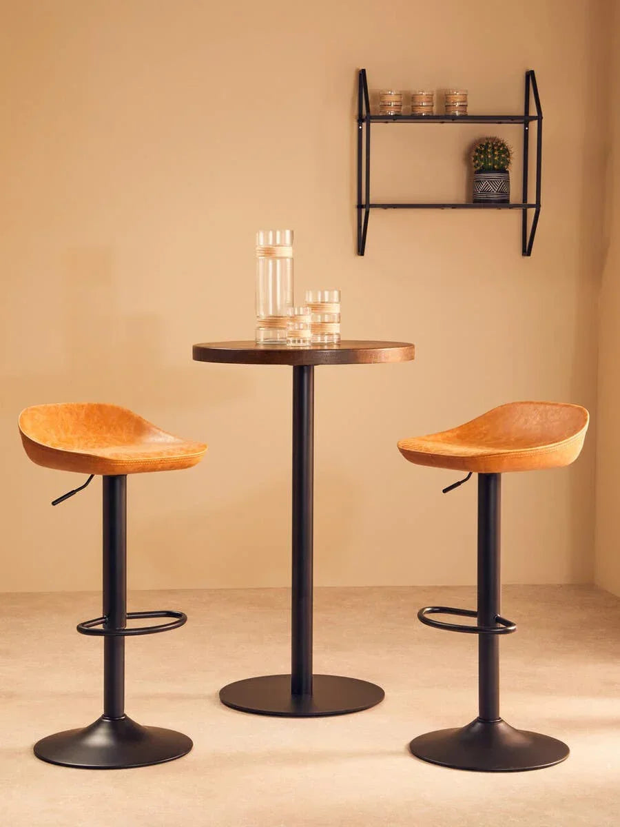 Leather bar stools with black metal bases and round table in modern dining setting