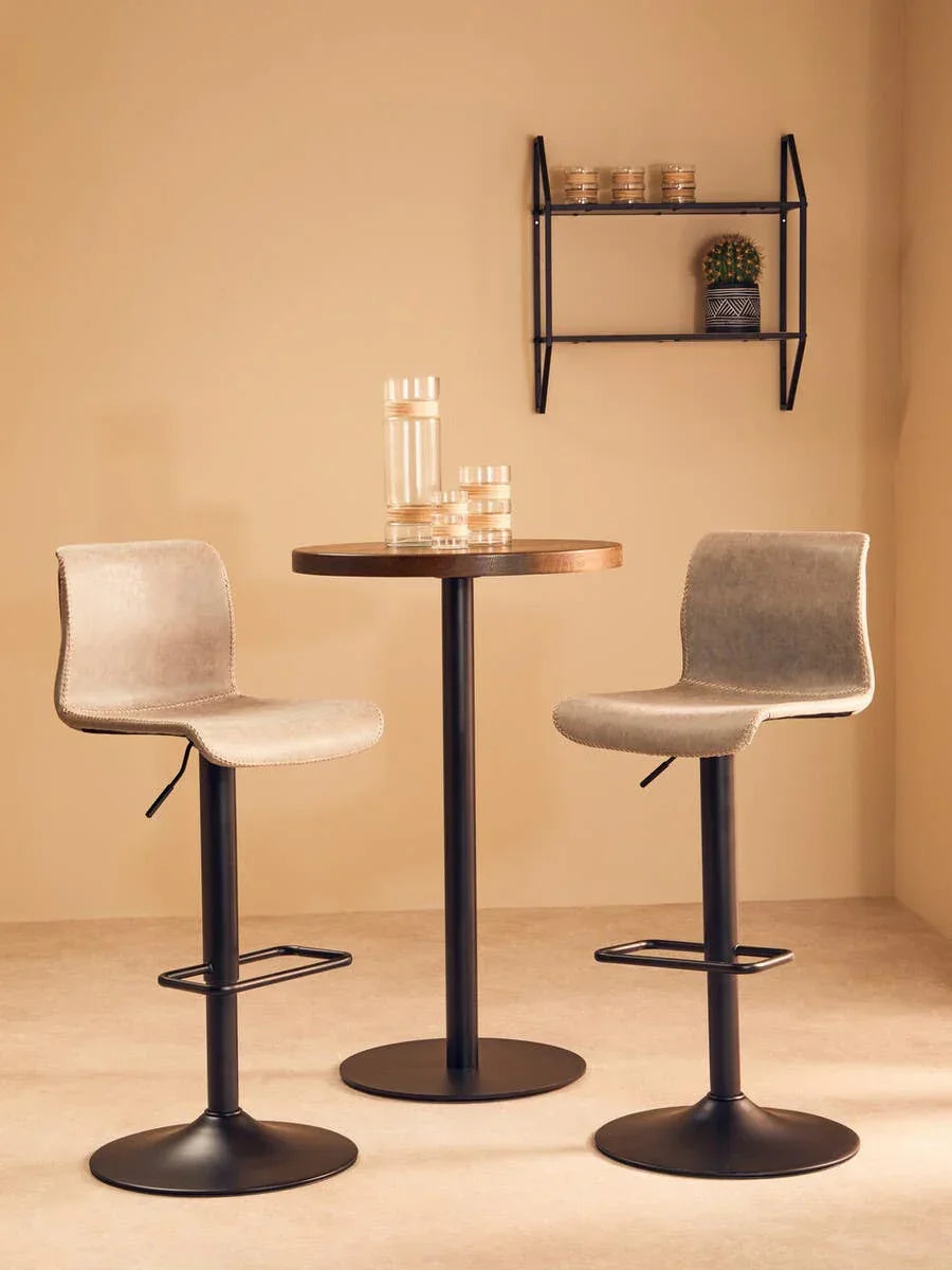 Beige bar stools with black metal bases and round table in modern dining set