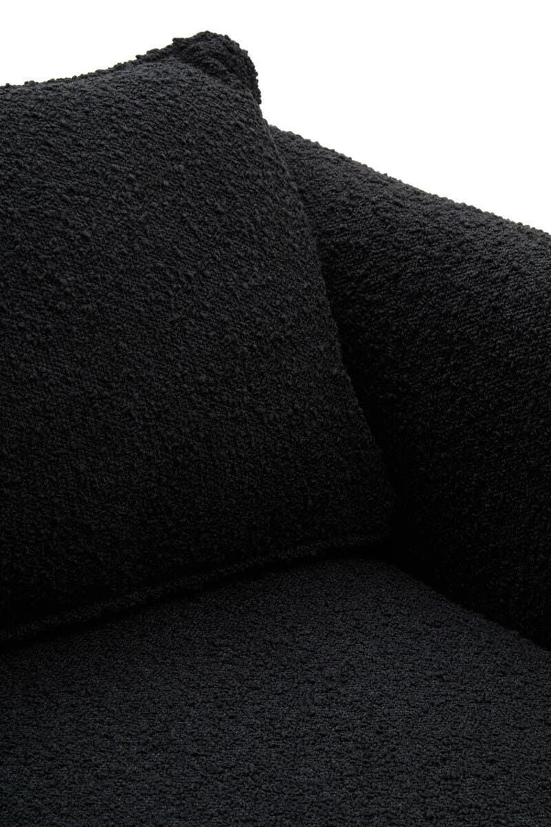 Black boucle sofa corner with textured fabric and matching cushion