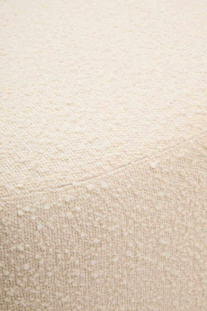 Close up of cream boucle fabric upholstery on furniture piece