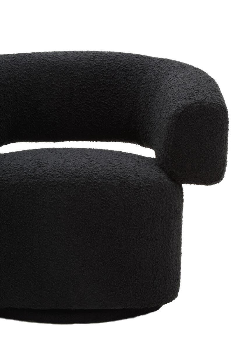 Curved black boucle fabric armchair with rounded armrest and seat, close-up view