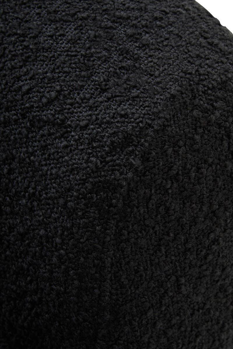 Black boucle upholstery fabric detail on furniture surface