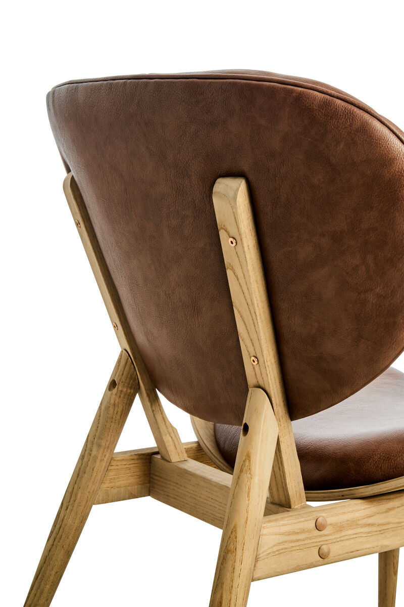 Brown leather effect chair featuring a rounded backrest and a sturdy elm wood frame.