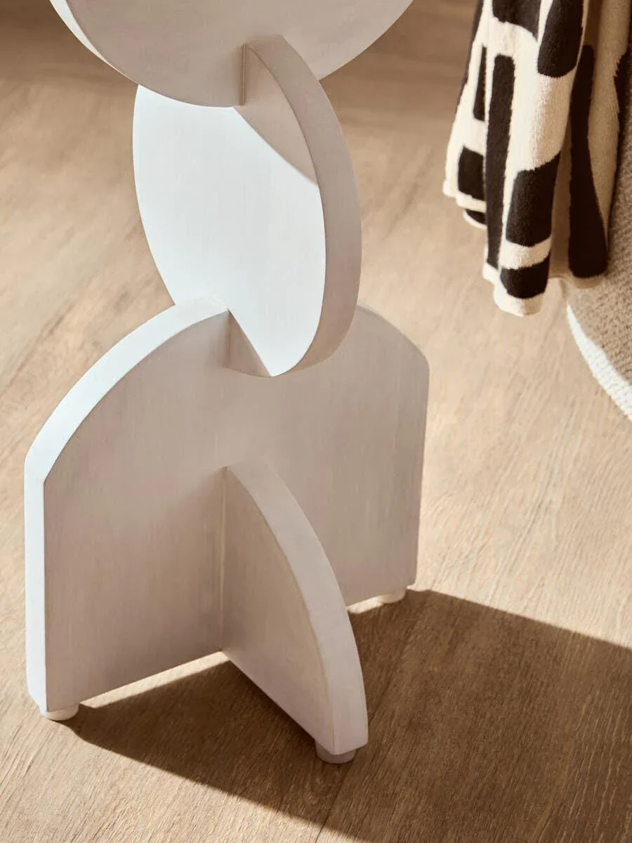 Close up of modern wooden furniture leg with geometric shapes on oak floor
