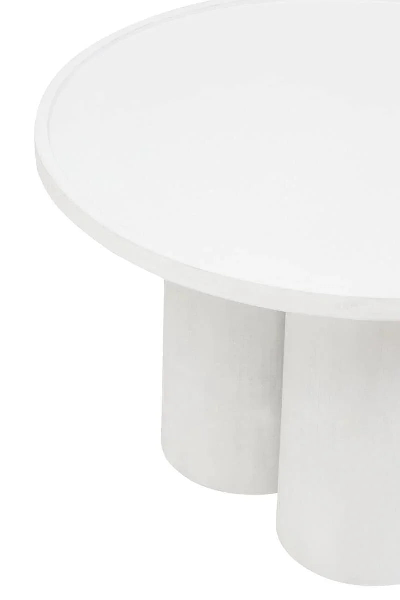 Round white coffee table with cylindrical legs, close-up on tabletop and base detail