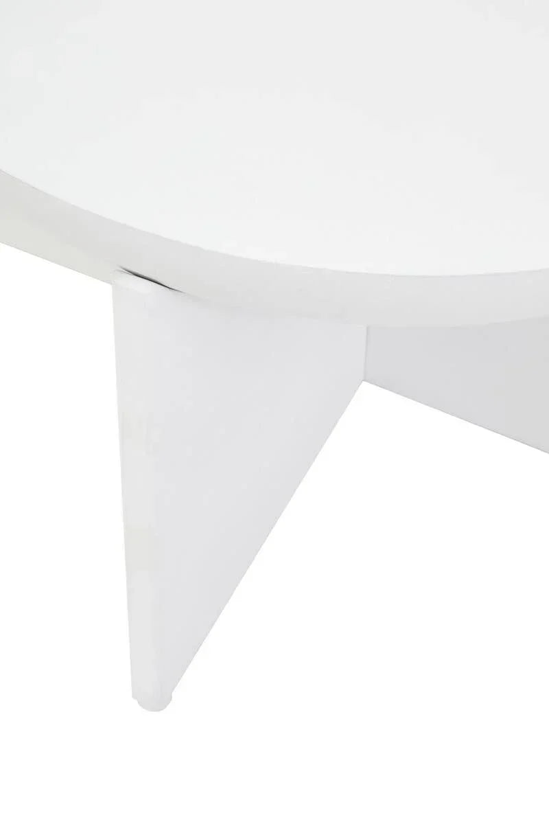 Closeup of white round coffee table with angled leg and smooth finish