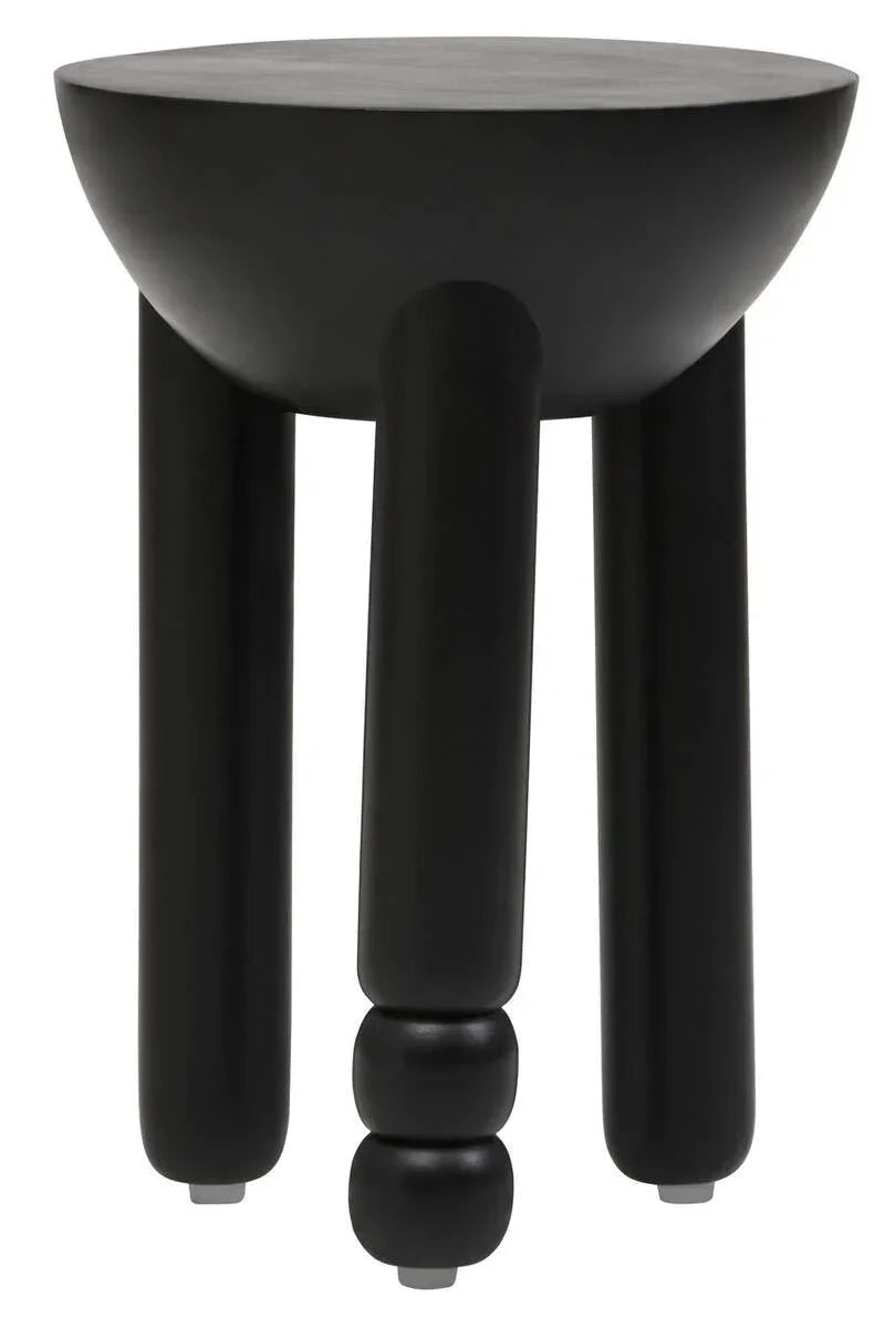 Black side table with round top and sculpted three-leg base, modern furniture accent