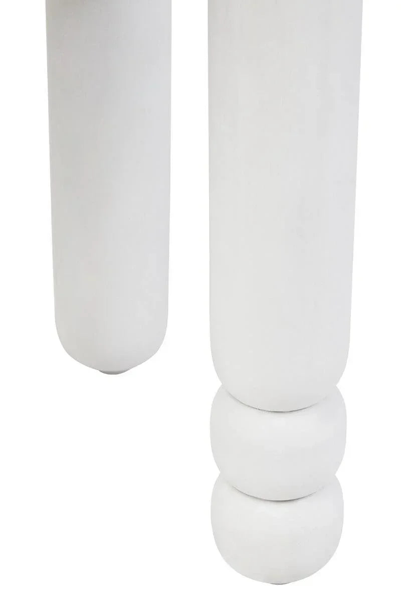 Close-up of white round wooden furniture legs with carved detail
