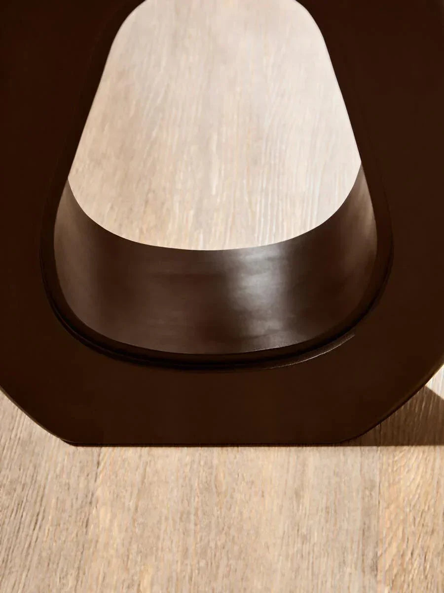 Close-up of dark wood table base on light oak flooring