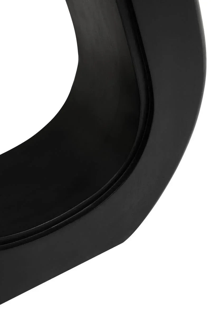 Close-up of black metal dining table base with smooth curved design