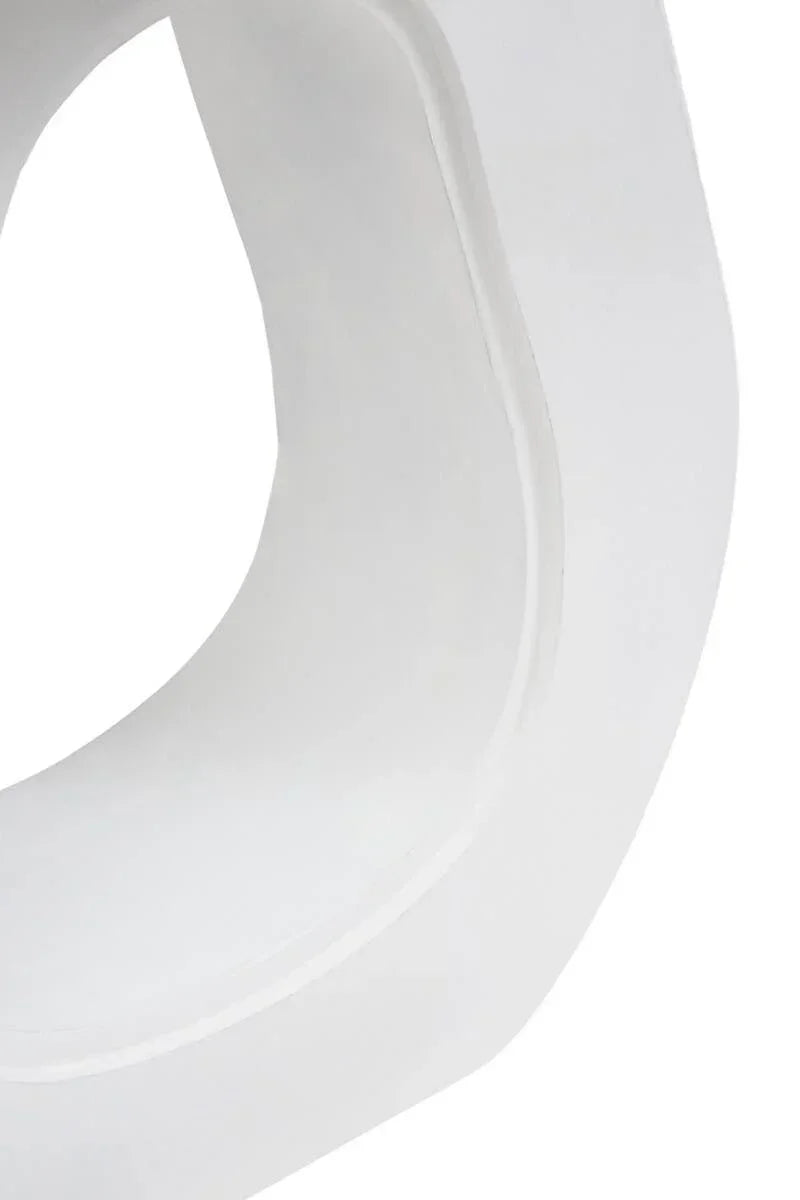 Close-up of white ceramic furniture base with curved modern design