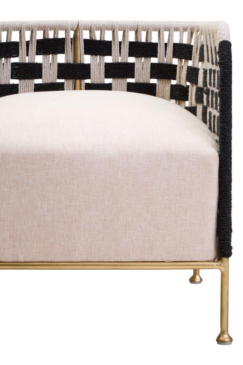 Contemporary sofa with woven rope arms, beige seat cushion and gold metal frame, front view