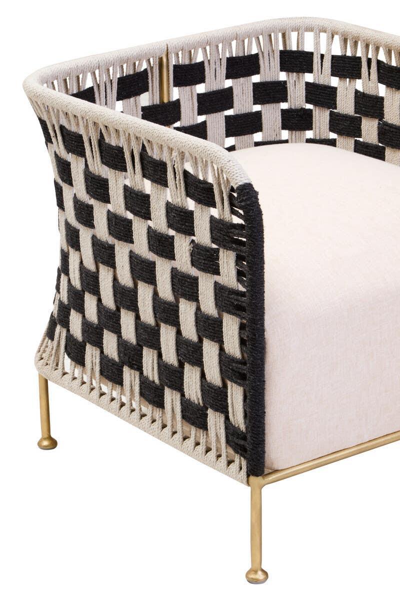 Modern armchair with black and cream woven rope sides, beige seat and brass legs