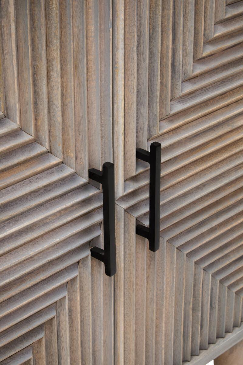 Detail of wooden cabinet doors with geometric paneling and black metal handles