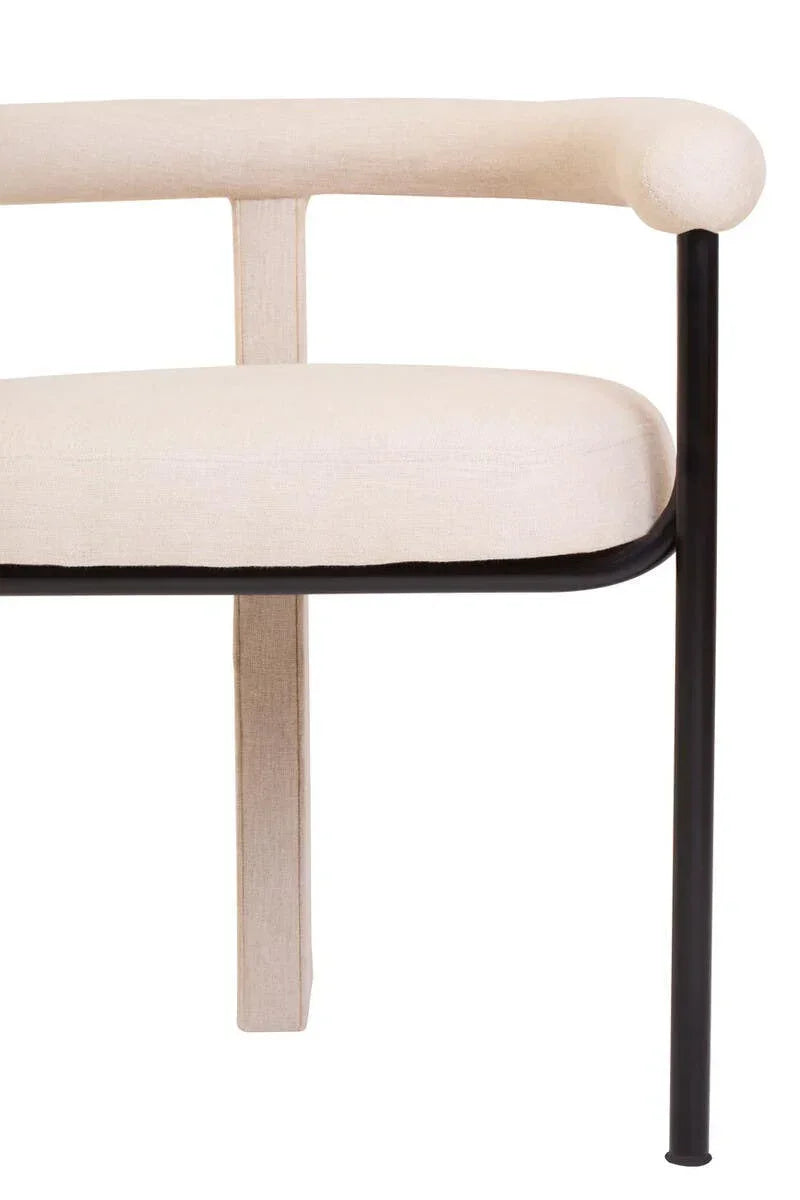 Beige fabric armchair with black metal frame, modern curved backrest, close-up view
