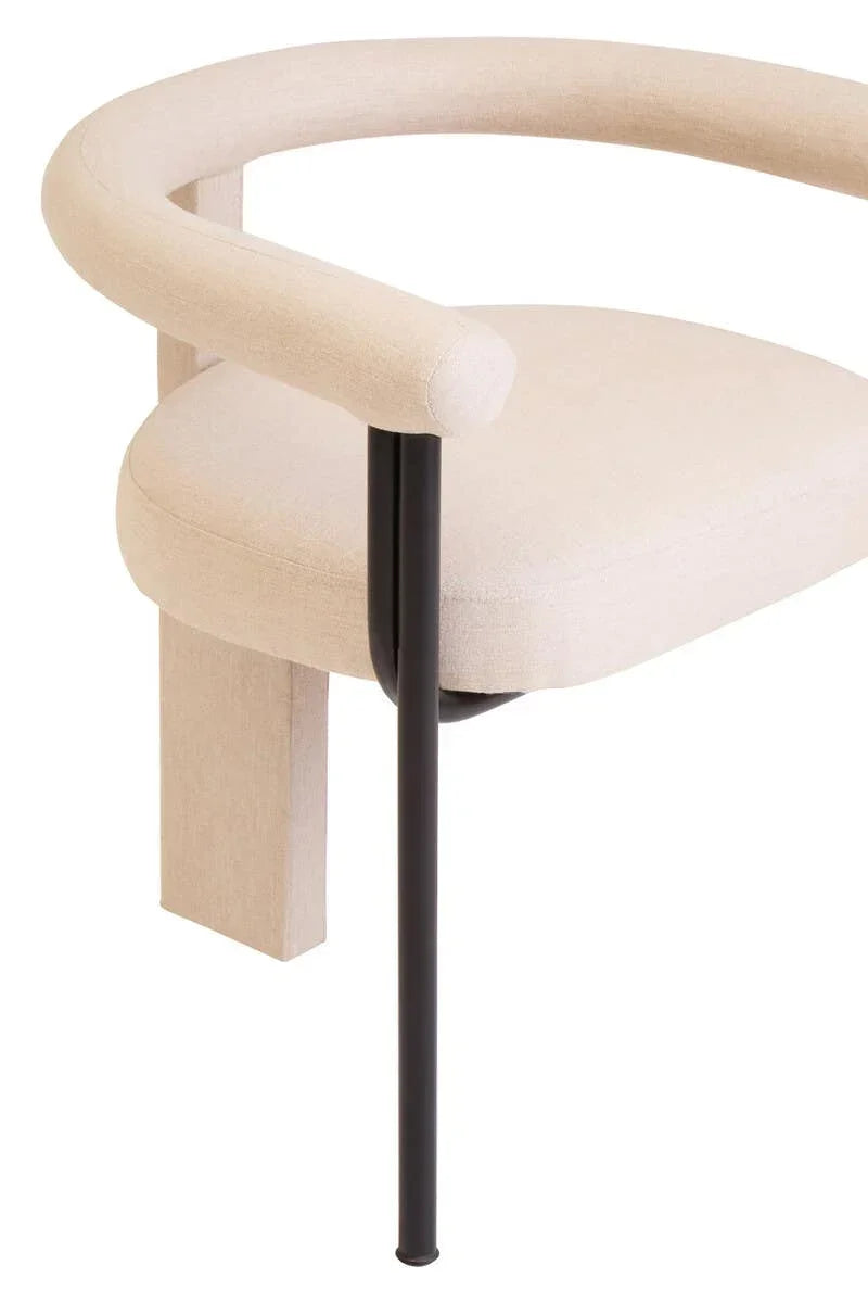 Beige upholstered dining chair with curved backrest and black metal leg, partial side view