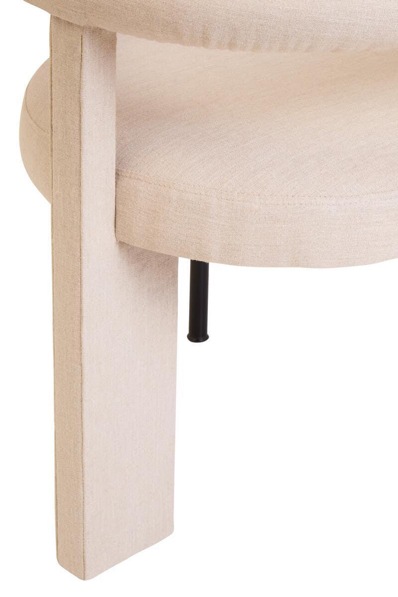 Beige upholstered chair leg and seat close-up highlighting fabric texture and modern design