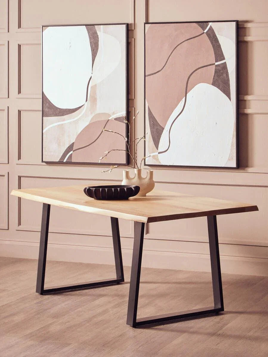 Modern wooden dining table with black metal legs in a neutral styled room