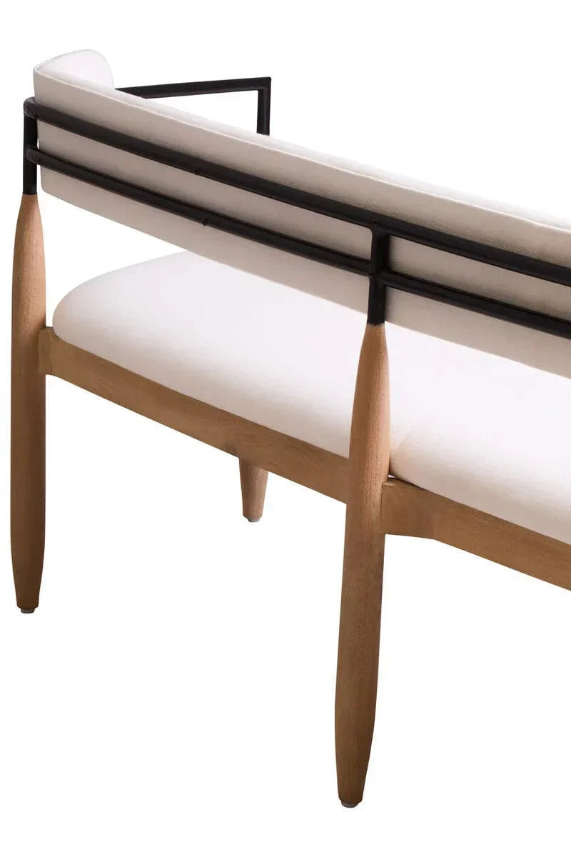 Modern dining bench with light wood legs, black metal frame, and white upholstered seat