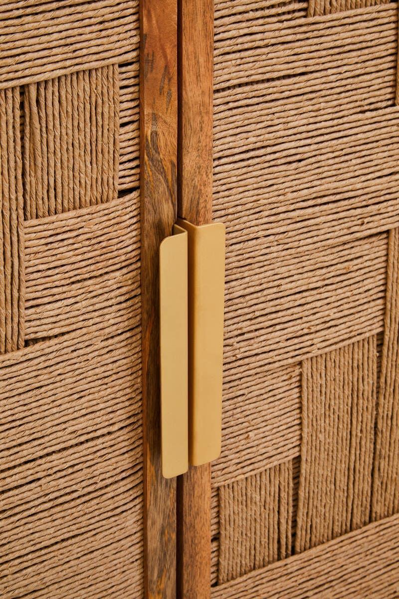 Close-up of storage cabinet with woven rope doors and brass handle