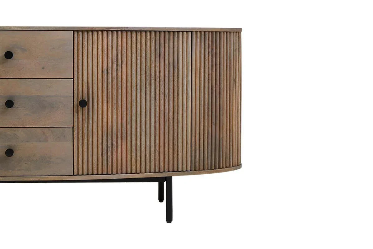 Wooden sideboard with ribbed door detail, three drawers, and black handles on metal legs